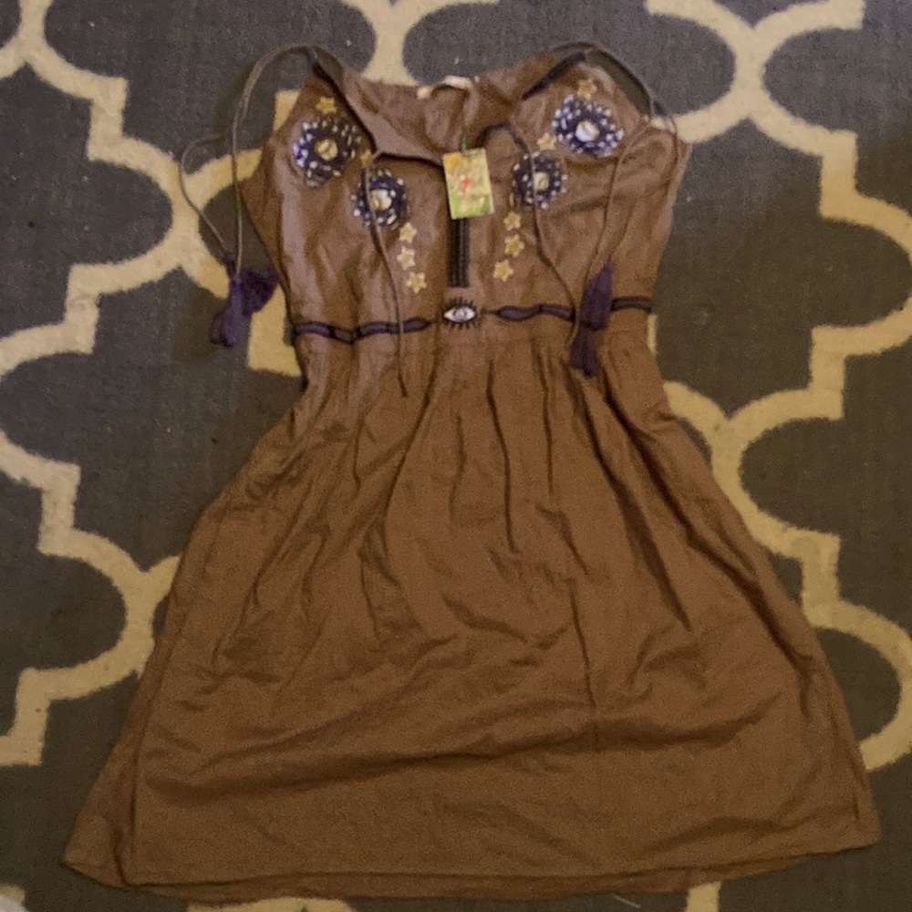 Brand New, tan, Sack’s dress with cute purple accents, and eye designs